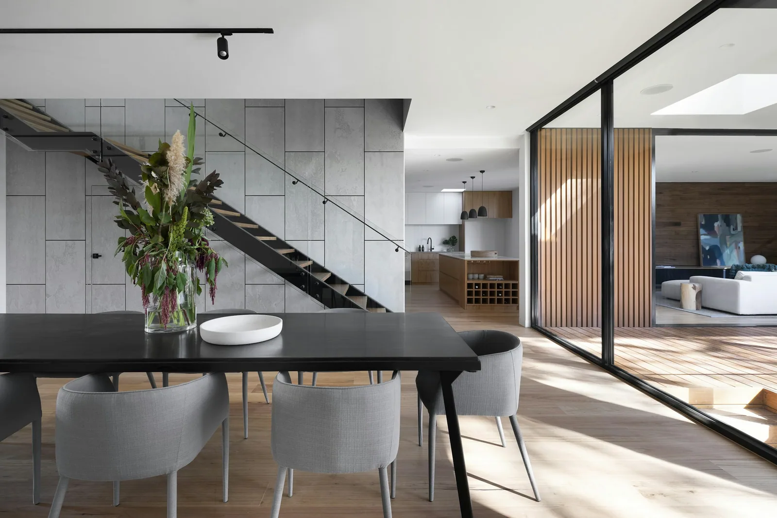 An open-plan family kitchen with an island and ceiling-height cabinetry
