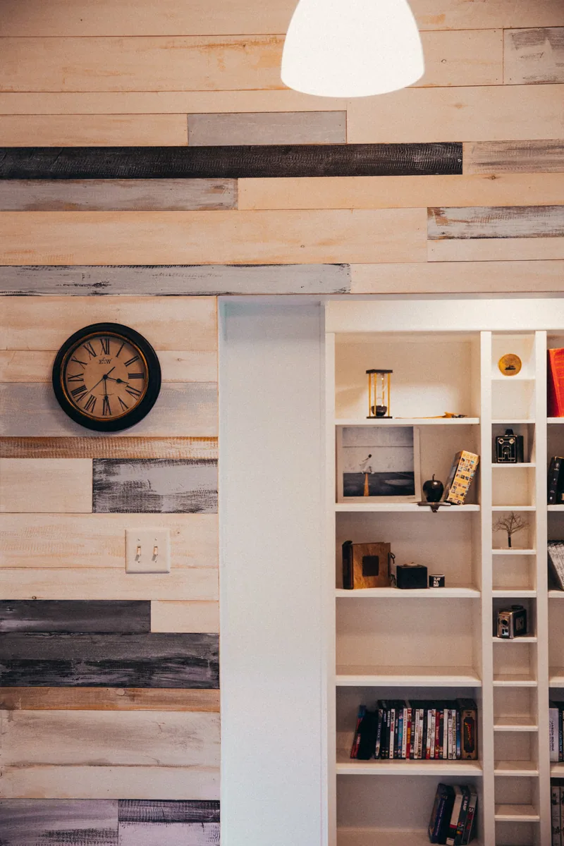Full-height wood panelled joinery wall with integrated open shelving