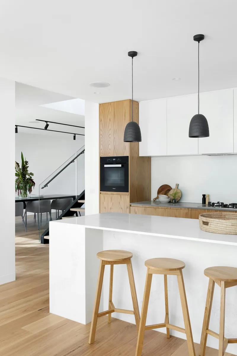 Mummy Mountain: minimal kitchen with pale timber island and stool seating