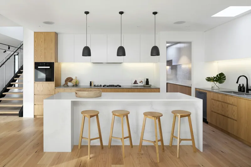 Oak and stone kitchen island with black pendants, Arcadia project