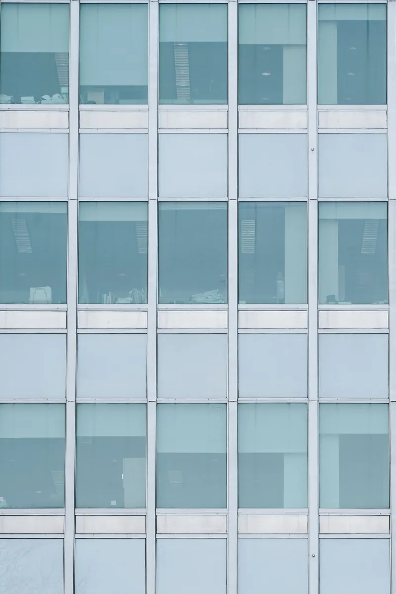 A glass office facade covered from two elevations