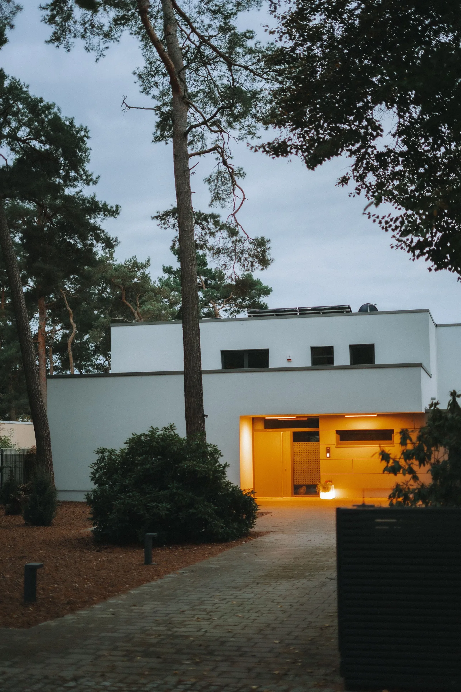 After: the same elevation lit and covered end to end