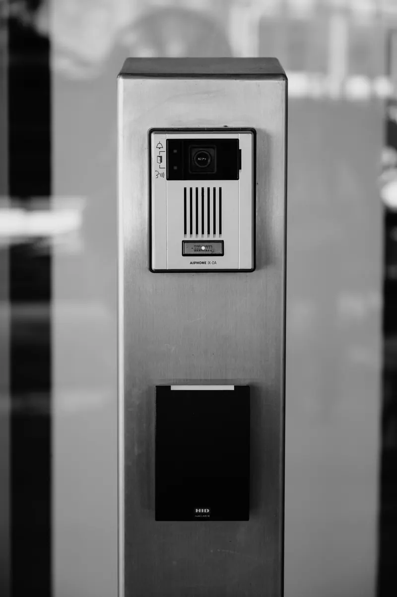 An intercom and access panel on a plain exterior wall