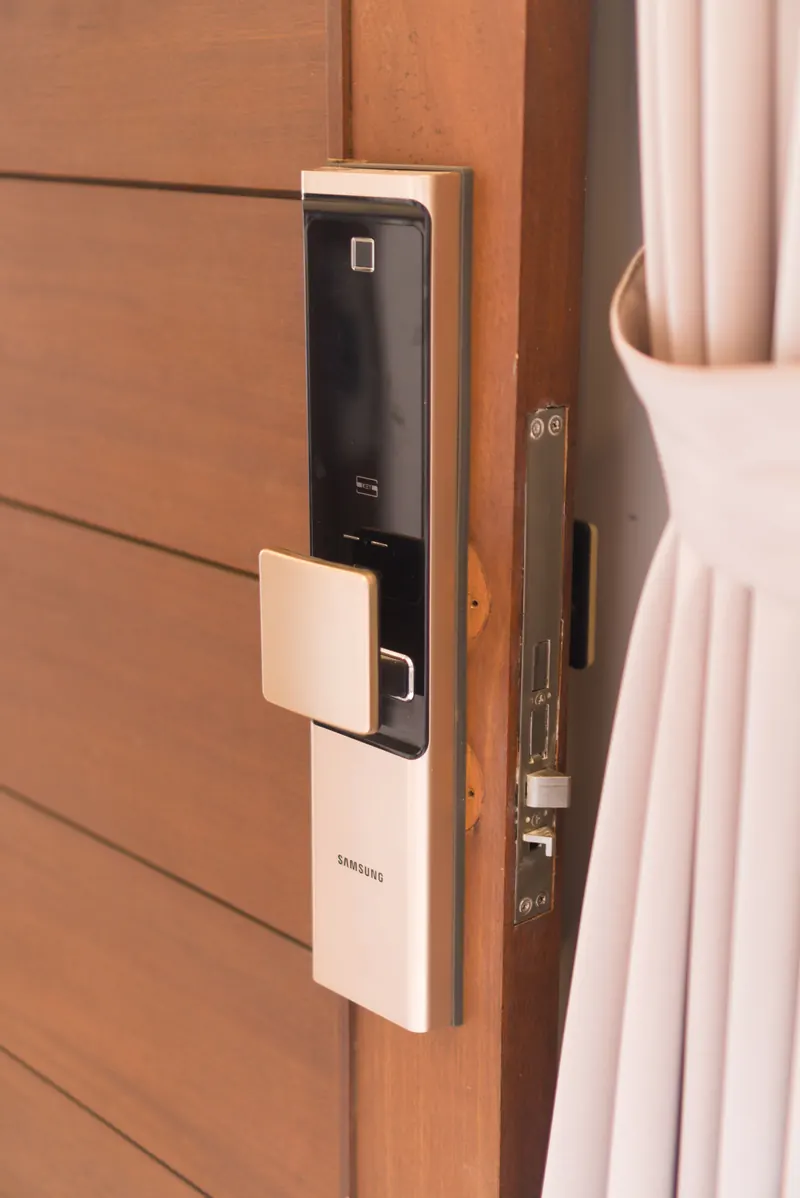 A smart lock and reader on a timber entrance door