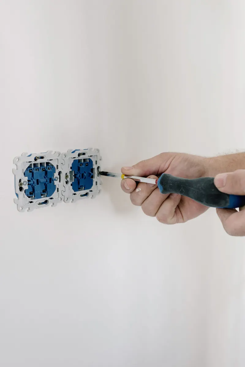 Hands terminating low-voltage wiring into a modular device