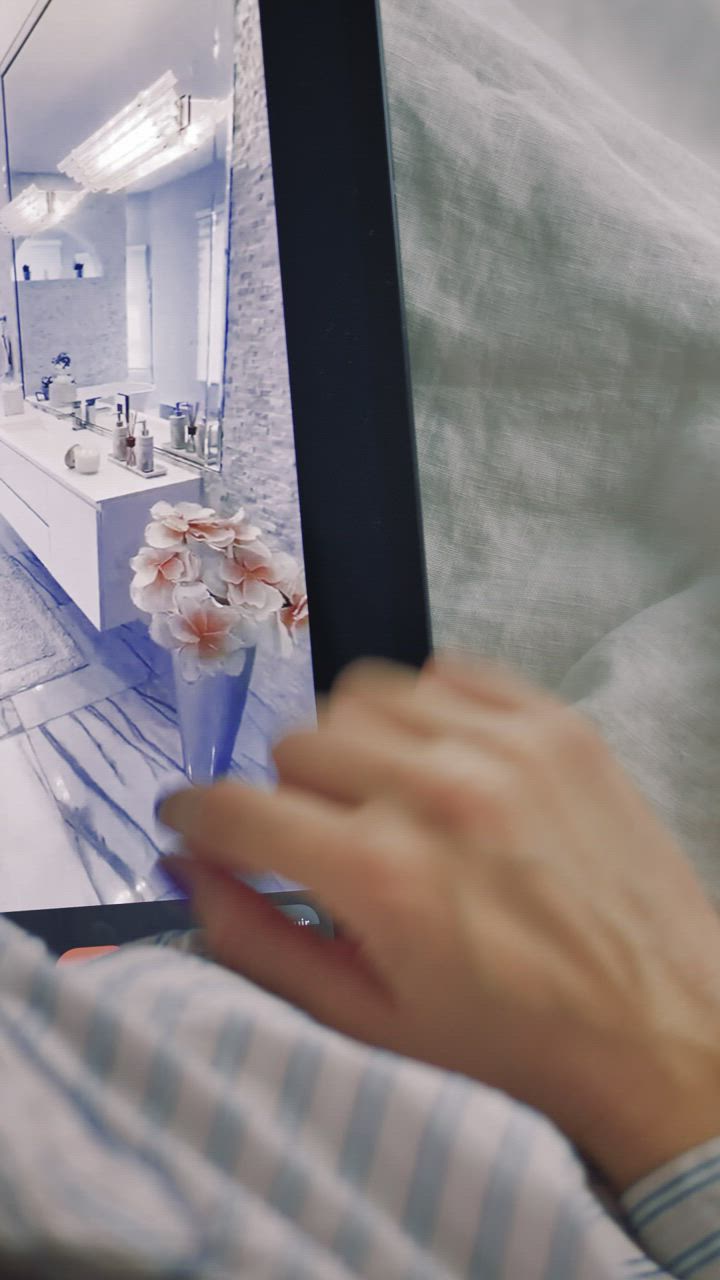 Designer reviewing interior renderings on a tablet